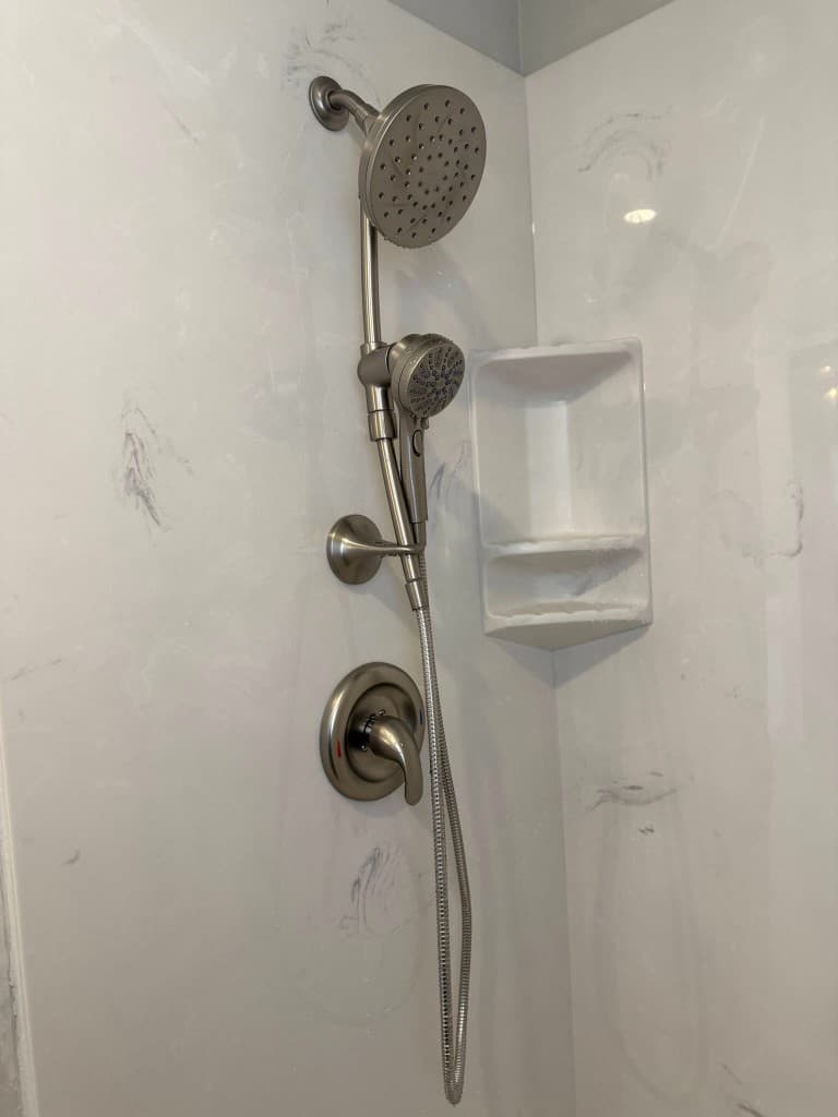 Marble shower with rain head and handheld fixture trim